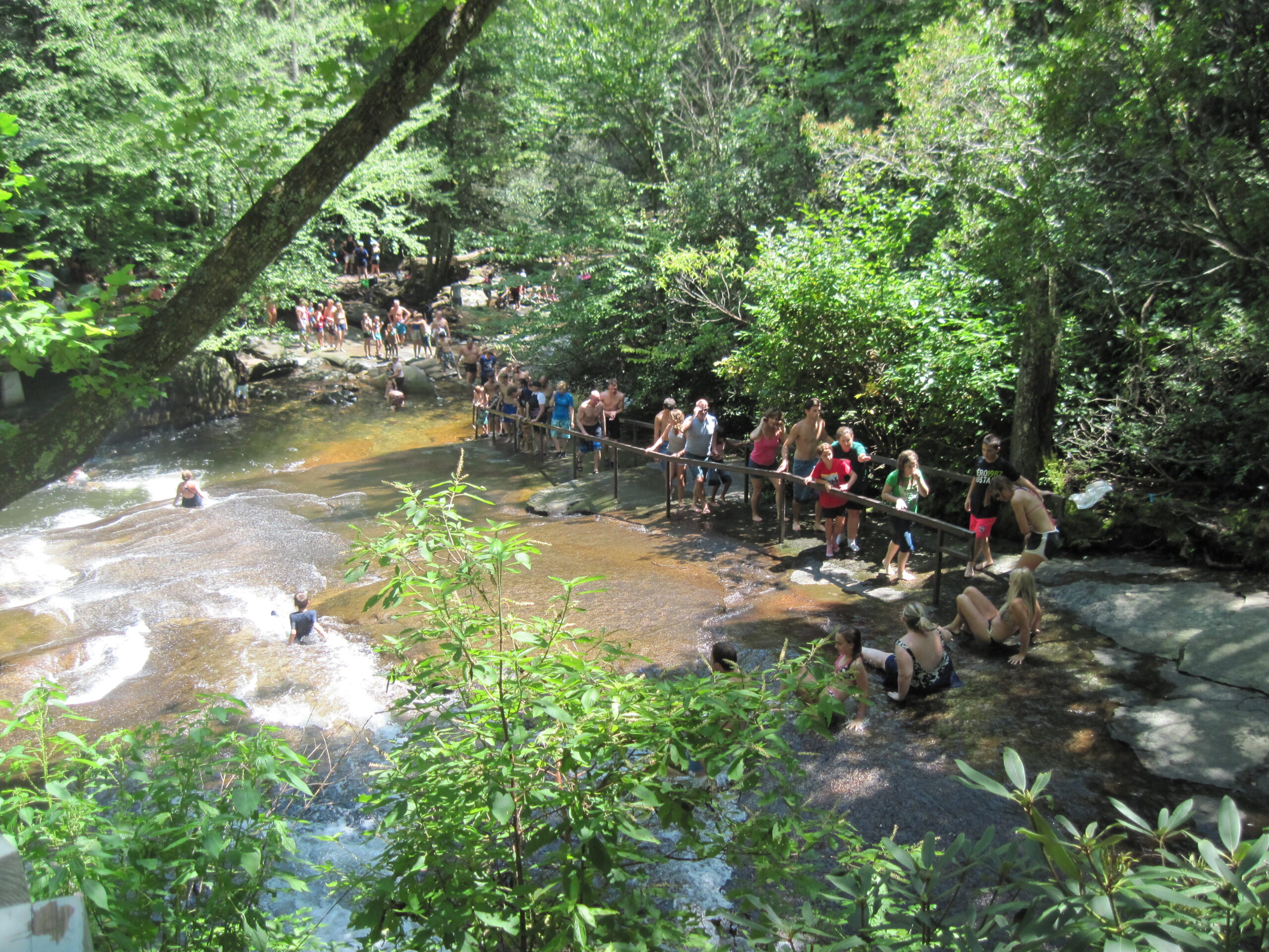 People sliding down Sliding Rock, a 60-foot natural water slide in Pisgah National Forest near Brevard NC