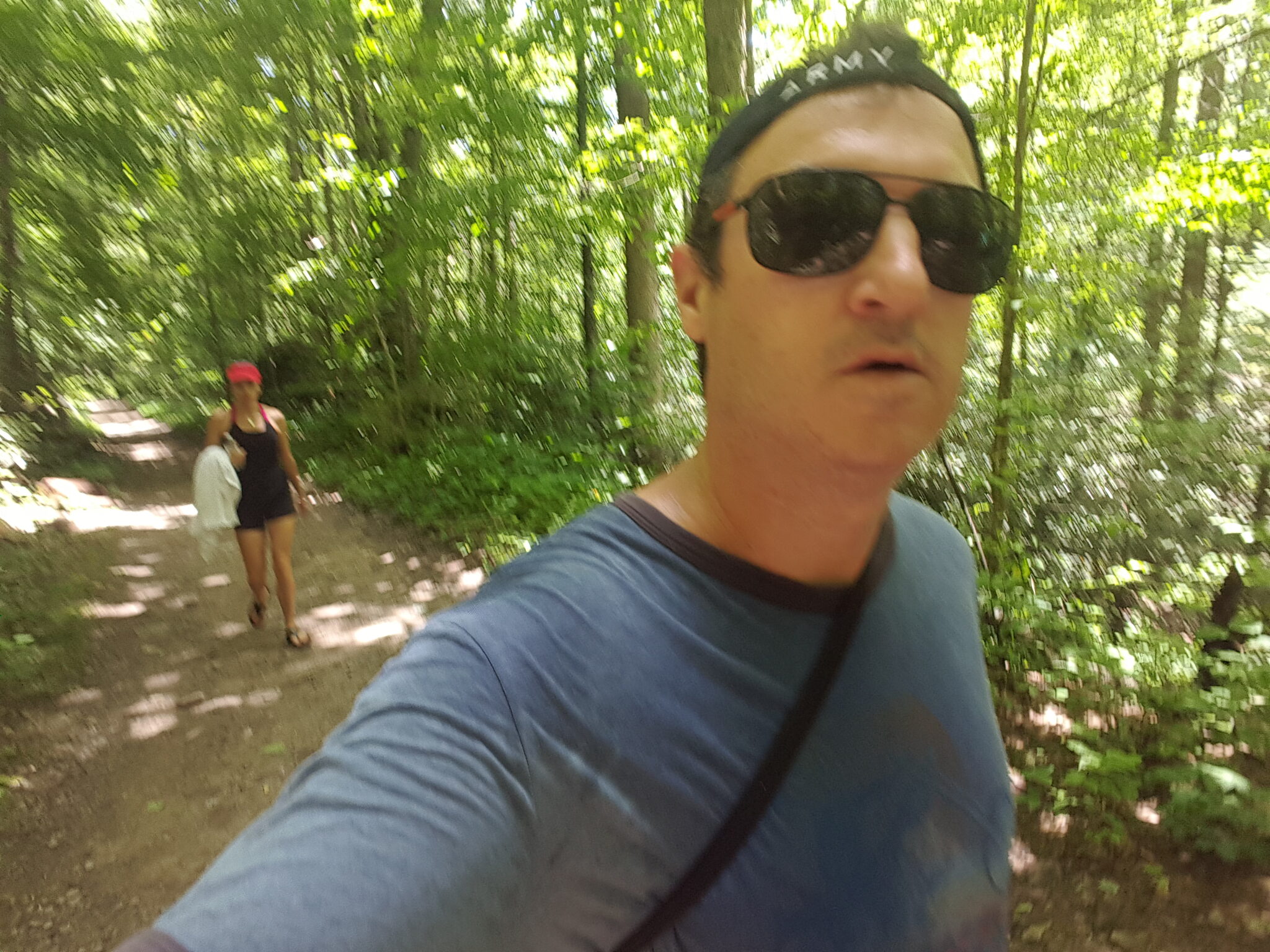 Hiking the shaded Big Creek Trail through lush green forest in the Great Smoky Mountains