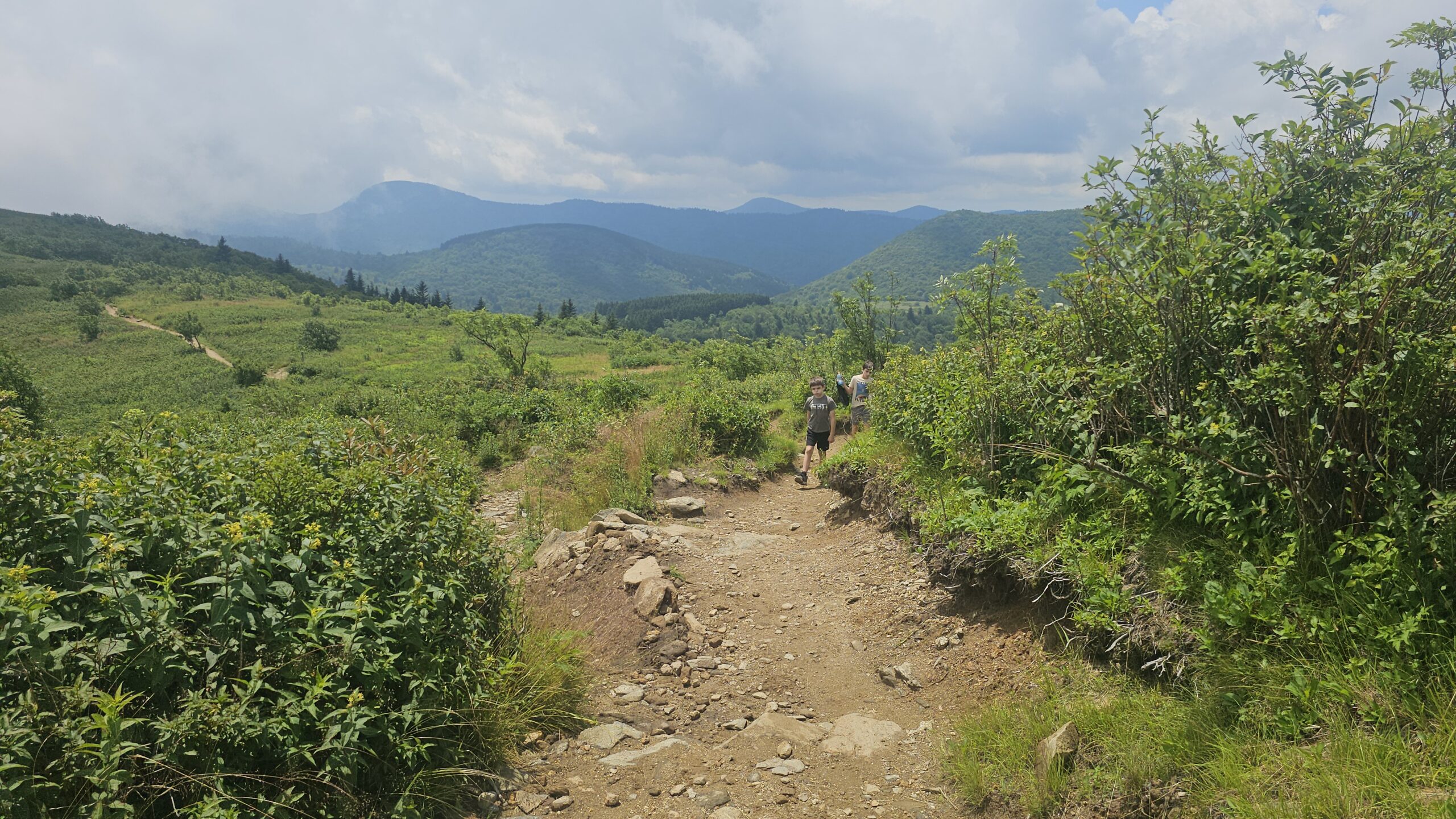 Hikers ascending rocky trail toward Black Balsam Knob summit on the Art Loeb Trail