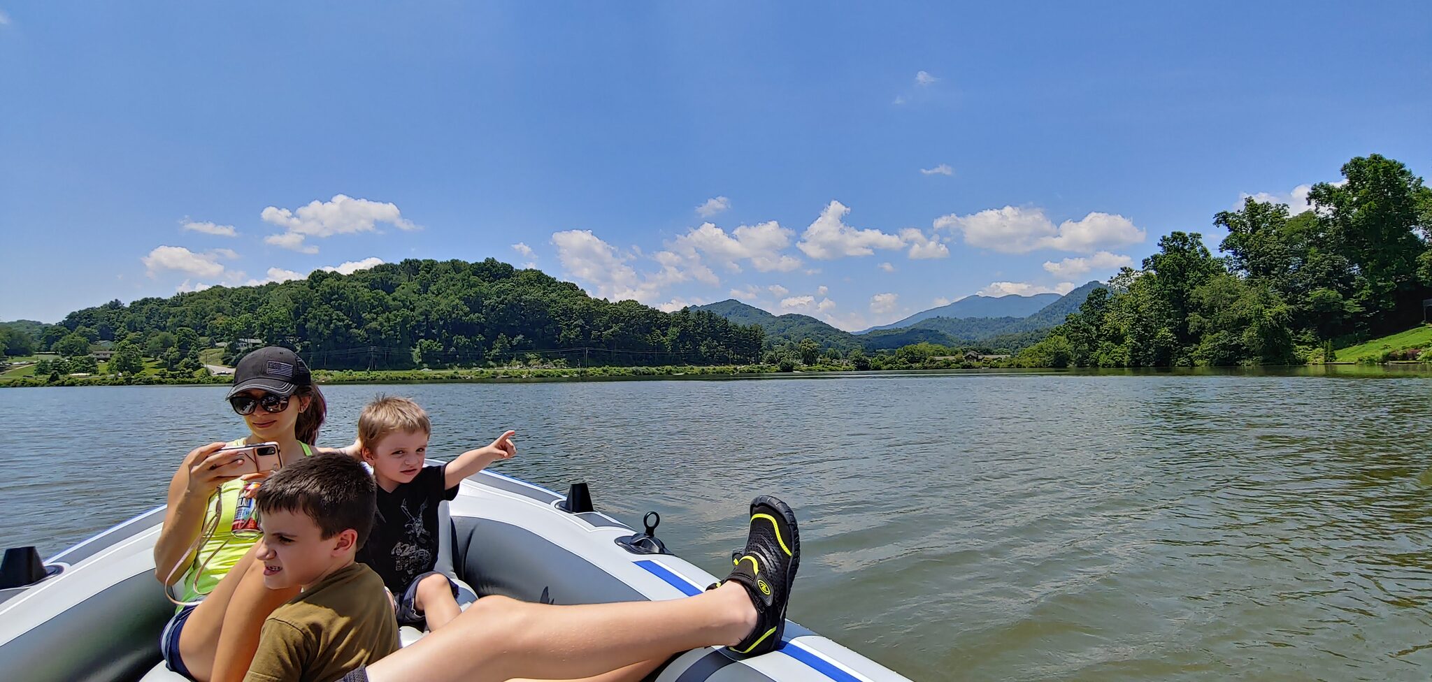 Family boating on Lake Junaluska with Blue Ridge Mountains in the background