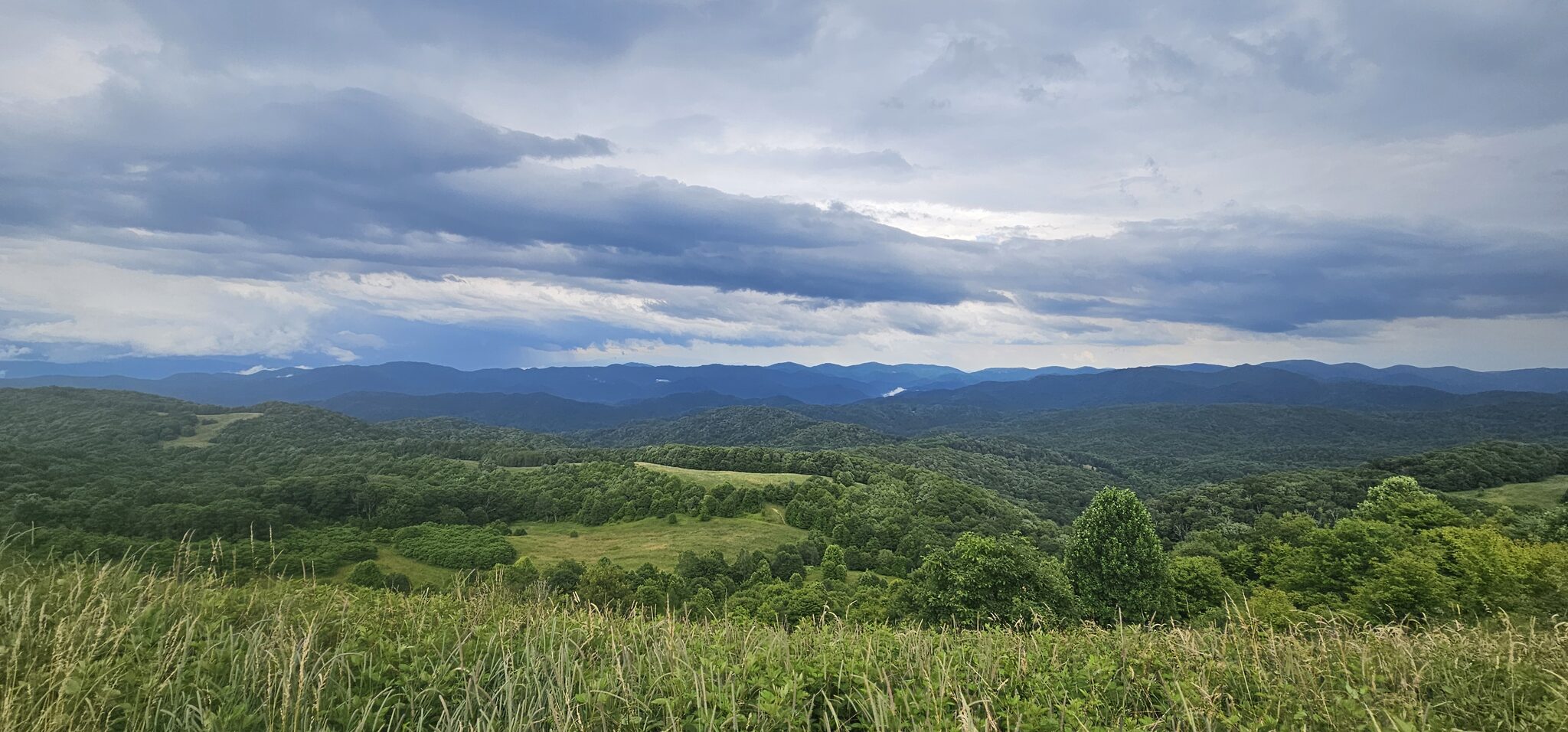 Panoramic view of the Blue Ridge Mountains from Max Patch under dramatic clouds