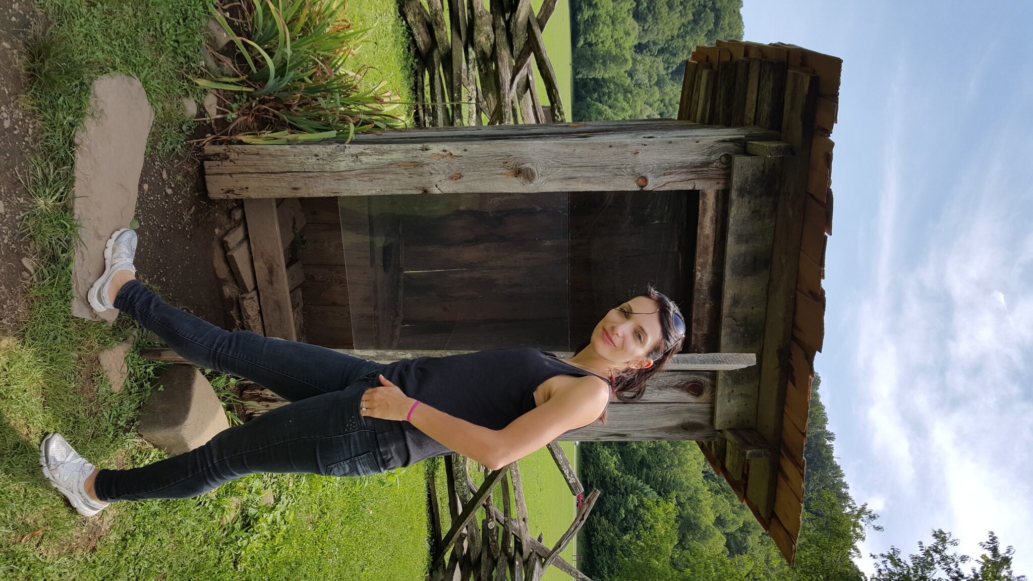 Posing at a historic homestead building at the Oconaluftee Mountain Farm Museum